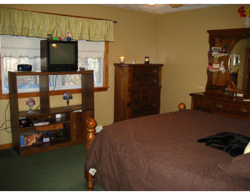 22 Albion Road Billerica, MA 01821 - Photo 22 of 26 a bedroom with a bed closet and flat tv screen