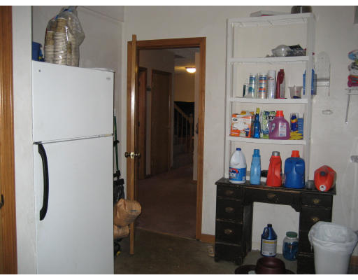 22 Albion Road Billerica, MA 01821 - Photo 23 of 26 a kitchen with a refrigerator and lots of clutter