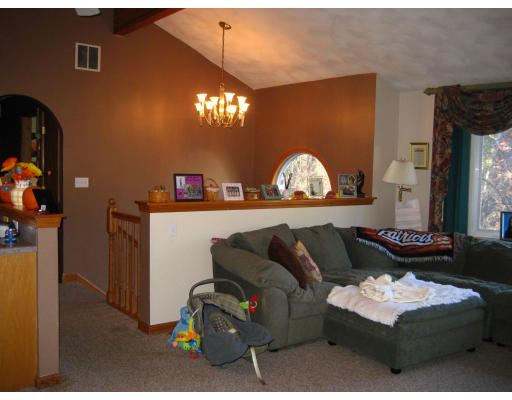 22 Albion Road Billerica, MA 01821 - Photo 5 of 26 a living room with furniture and a chandelier