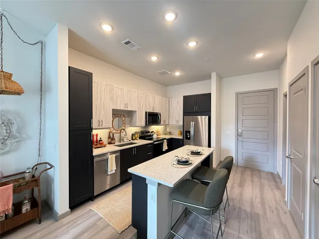 a kitchen with a refrigerator a stove top oven a sink and dishwasher