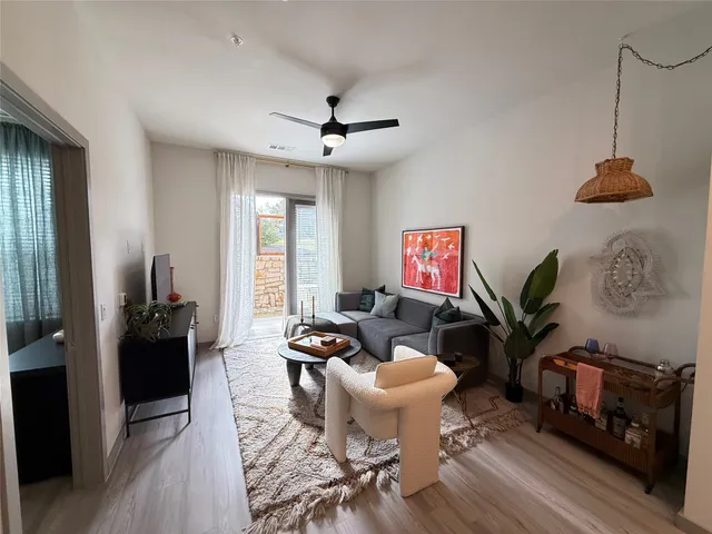 a living room with furniture a rug and a window