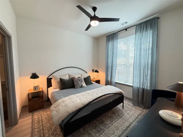 a bedroom with a bed couch and a window