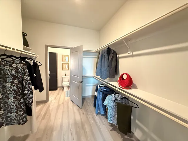a view of a room with wooden floor and windows