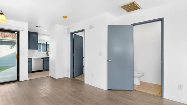 a view of a kitchen with a sink and a refrigerator