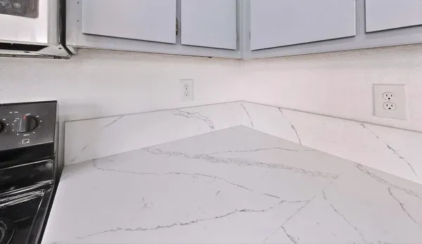 a view of a kitchen with white cabinets