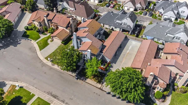 an aerial view of multiple houses with yard