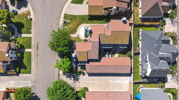an aerial view of houses with yard