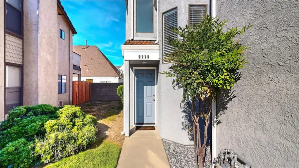 a house with potted plants in front of it
