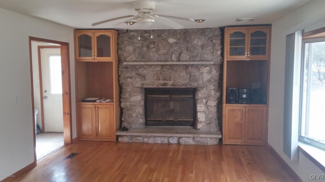 1412 Kroucher Road Stroudsburg, PA 18360 - Photo 16 of 40 an empty room with wooden floor a ceiling fan and windows