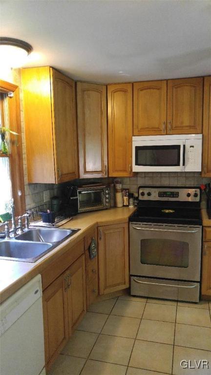 1412 Kroucher Road Stroudsburg, PA 18360 - Photo 17 of 40 a kitchen with stainless steel appliances a stove sink and cabinets