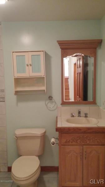 1412 Kroucher Road Stroudsburg, PA 18360 - Photo 35 of 40 a bathroom with a granite countertop toilet sink and mirror