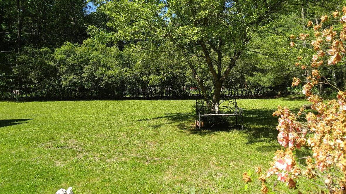 1412 Kroucher Road Stroudsburg, PA 18360 - Photo 6 of 40 a view of a garden with a bench