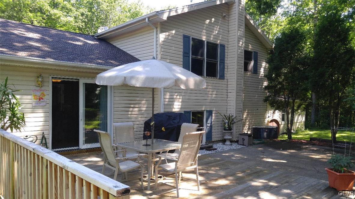 1412 Kroucher Road Stroudsburg, PA 18360 - Photo 10 of 40 a view of a patio with table and chairs under an umbrella