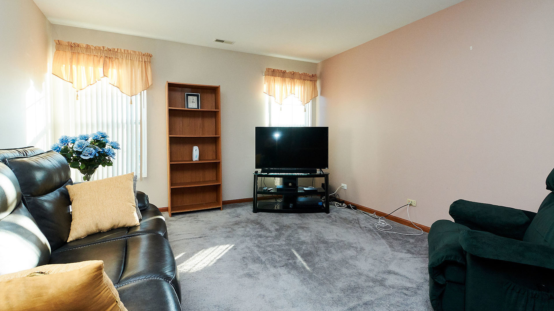 1989 West Cobblestone Road, Unit 1989 Romeoville, IL 60446 - Photo 22 of 51 a living room with furniture and a flat screen tv