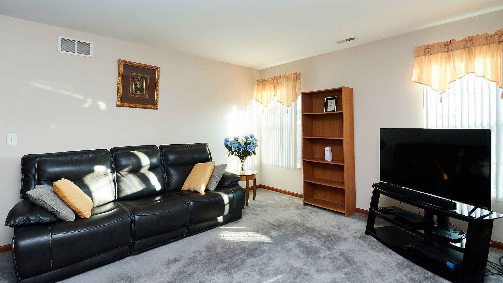 1989 West Cobblestone Road, Unit 1989 Romeoville, IL 60446 - Photo 23 of 51 a living room with furniture and a flat screen tv