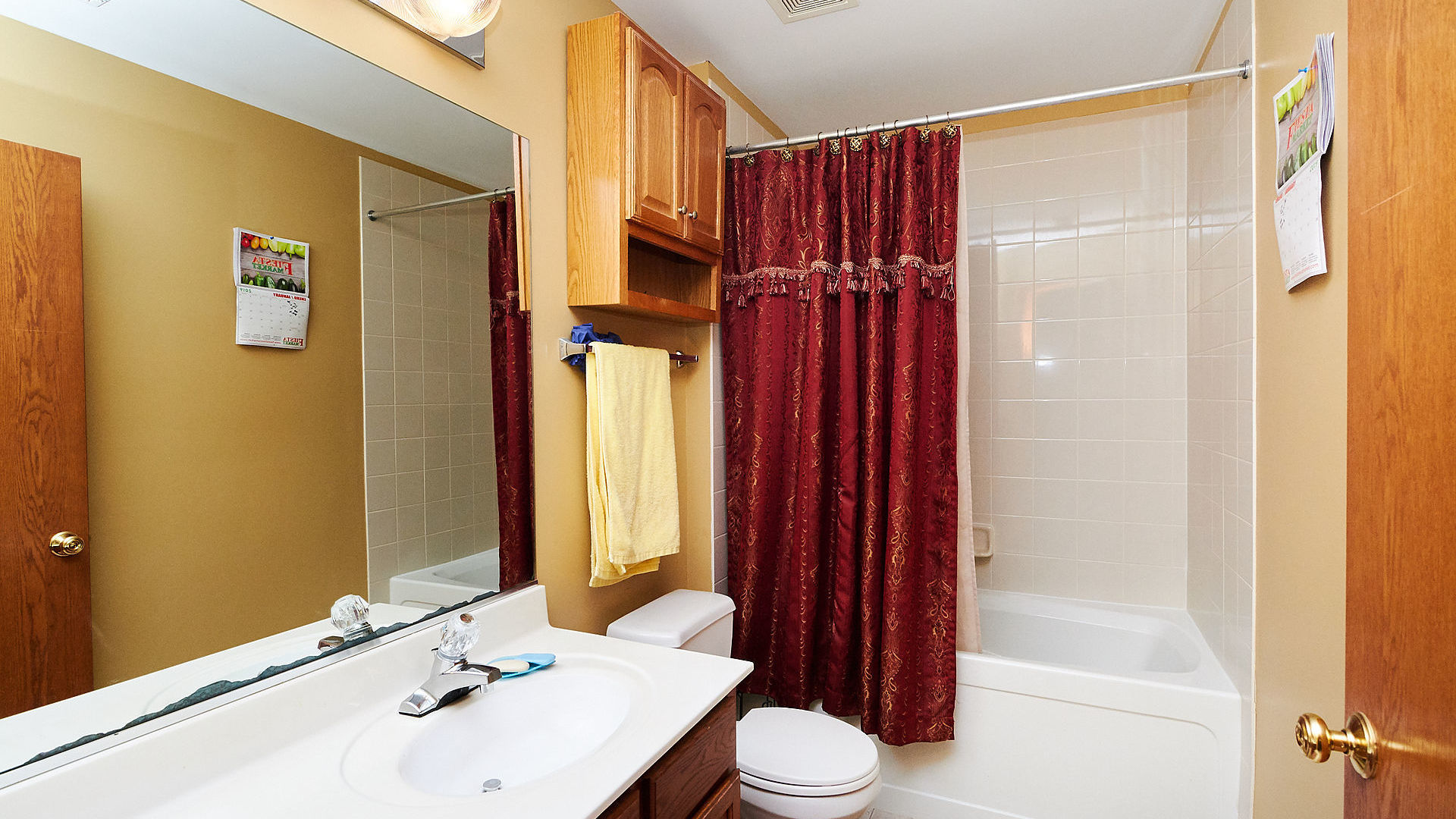 1989 West Cobblestone Road, Unit 1989 Romeoville, IL 60446 - Photo 32 of 51 a bathroom with a sink a toilet and shower curtain