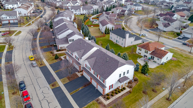 1989 West Cobblestone Road, Unit 1989 Romeoville, IL 60446 - Photo 41 of 51 an aerial view of residential houses with outdoor space