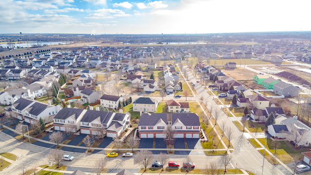1989 West Cobblestone Road, Unit 1989 Romeoville, IL 60446 - Photo 47 of 51 an aerial view of residential houses with outdoor space