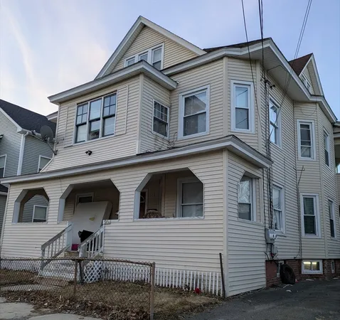 a front view of a house with iron stairs