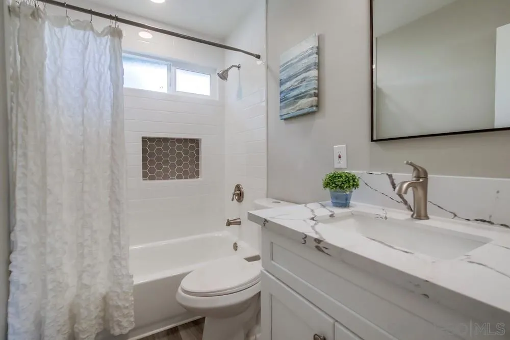 10110 Strathmore Drive Santee, CA 92071 - Photo 15 of 45 a bathroom with a sink a toilet and shower