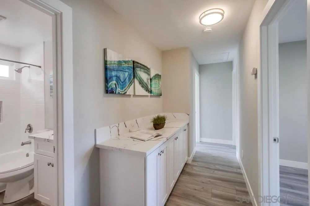 10110 Strathmore Drive Santee, CA 92071 - Photo 16 of 45 a bathroom with a sink a toilet and a shower