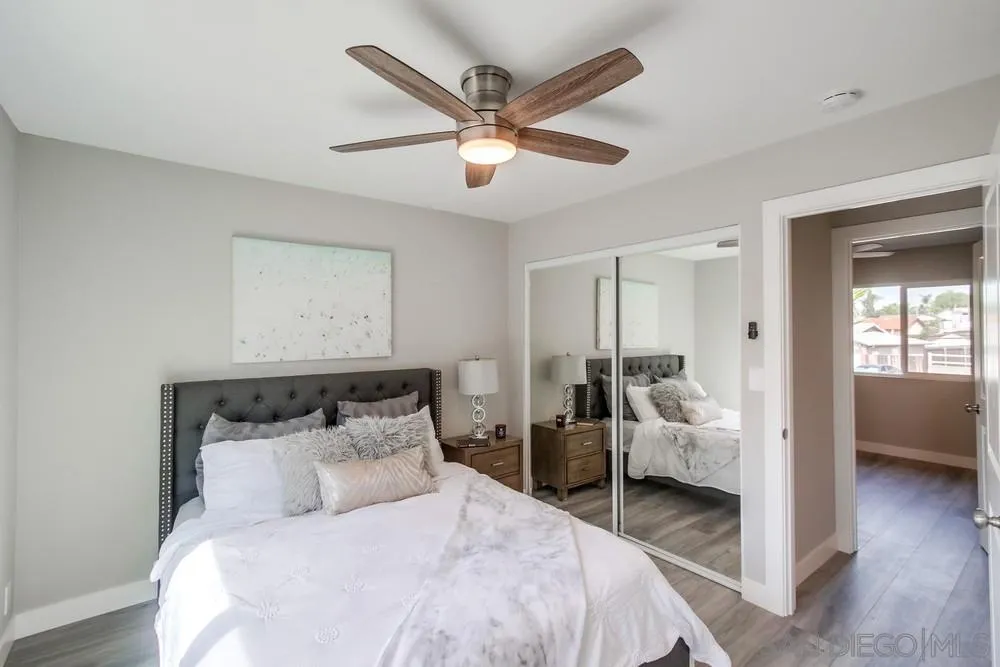 10110 Strathmore Drive Santee, CA 92071 - Photo 17 of 45 a bedroom with a bed and a chandelier