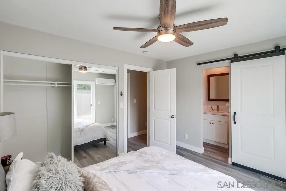 10110 Strathmore Drive Santee, CA 92071 - Photo 19 of 45 a bedroom with a bed and a ceiling fan