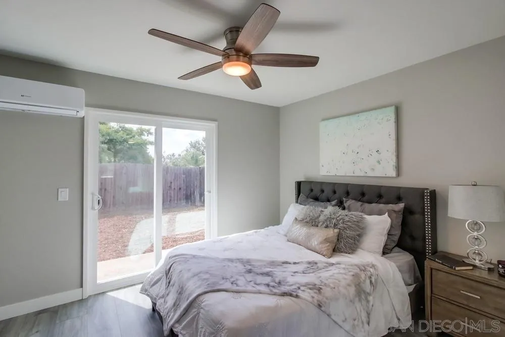 10110 Strathmore Drive Santee, CA 92071 - Photo 20 of 45 a bedroom with a large bed and a window