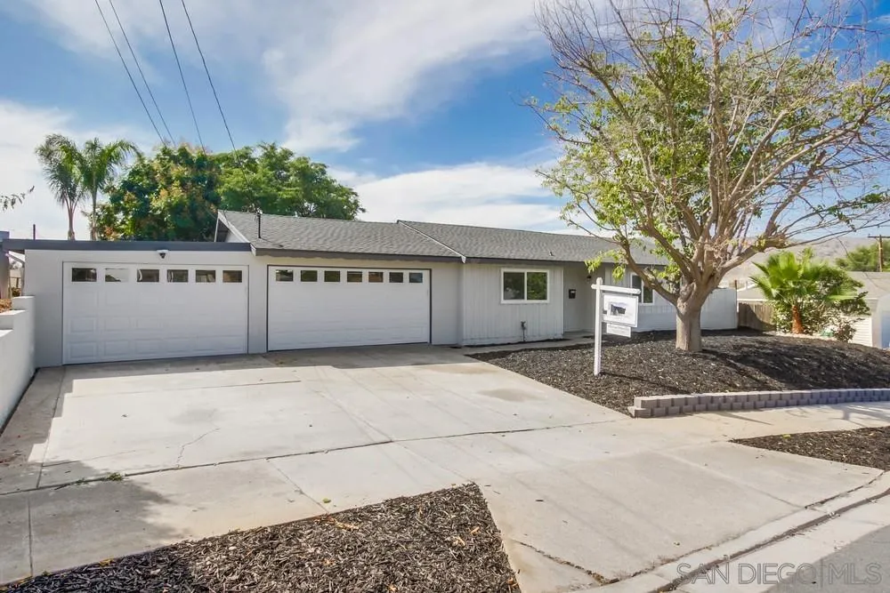 10110 Strathmore Drive Santee, CA 92071 - Photo 2 of 45 a view of a white house with a large tree