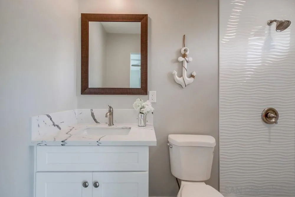 10110 Strathmore Drive Santee, CA 92071 - Photo 22 of 45 a bathroom with a toilet sink and mirror