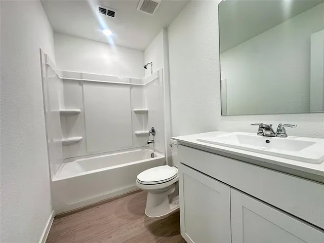 a bathroom with a sink a toilet and a bathtub