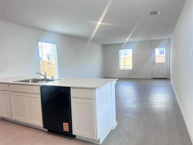a kitchen with granite countertop a sink and a stove top oven