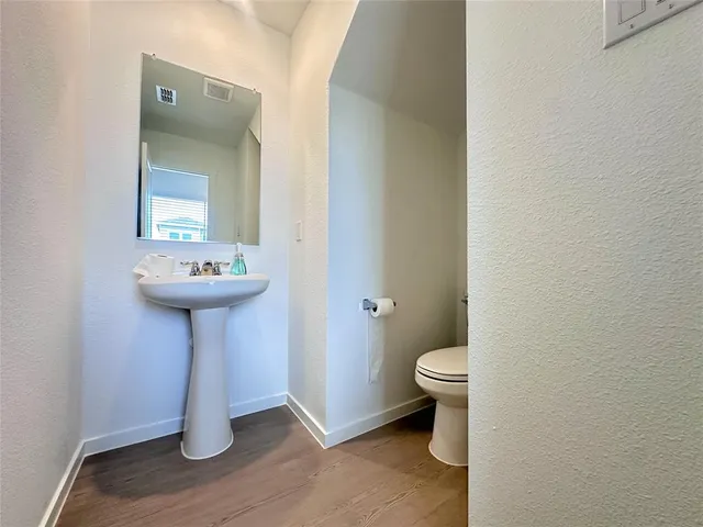 a bathroom with a sink toilet and a mirror
