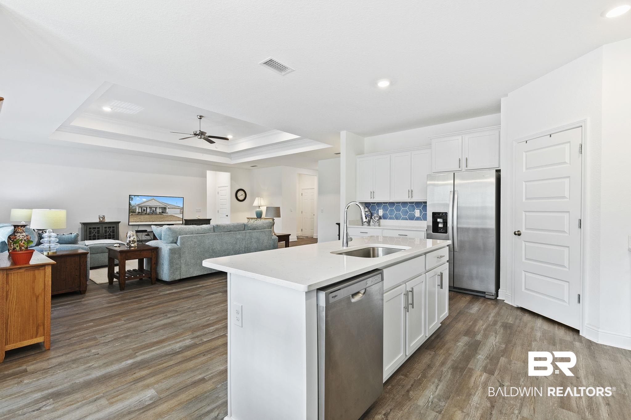 1141 Pencarro Boulevard Foley, AL 36535 - Photo 18 of 70 Kitchen with white cabinetry, an island with sink, appliances with stainless steel finishes, and sink