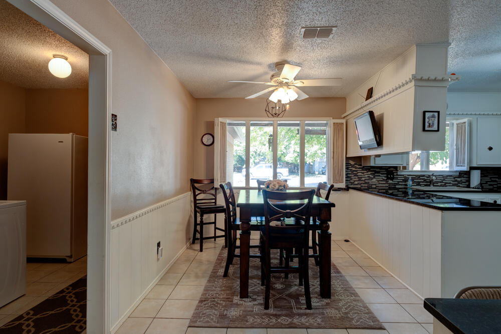 4509 62nd Street Lubbock, TX 79414 - Photo 11 of 20 a view of a dining room with furniture and a chandelier