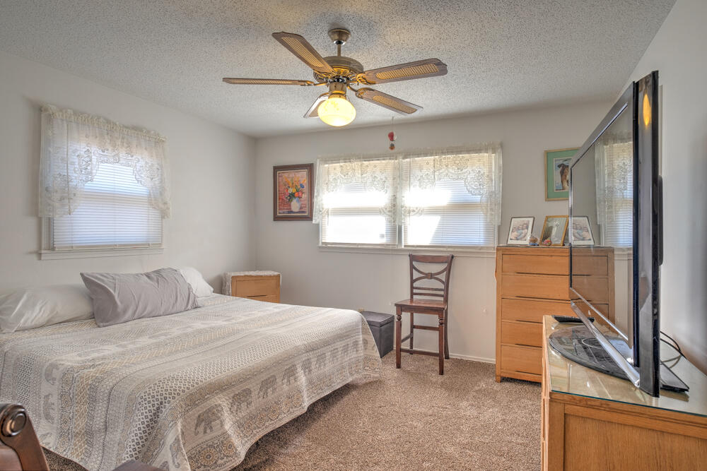 4509 62nd Street Lubbock, TX 79414 - Photo 14 of 20 a bedroom with a large bed and a window