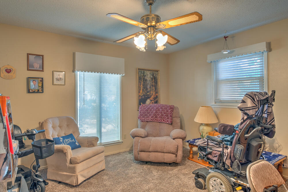 4509 62nd Street Lubbock, TX 79414 - Photo 16 of 20 a living room with furniture and a chandelier