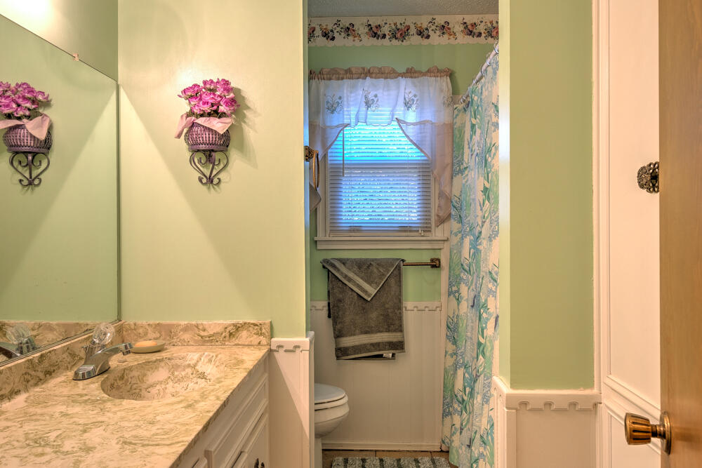 4509 62nd Street Lubbock, TX 79414 - Photo 17 of 20 a bathroom with a granite countertop sink and a mirror