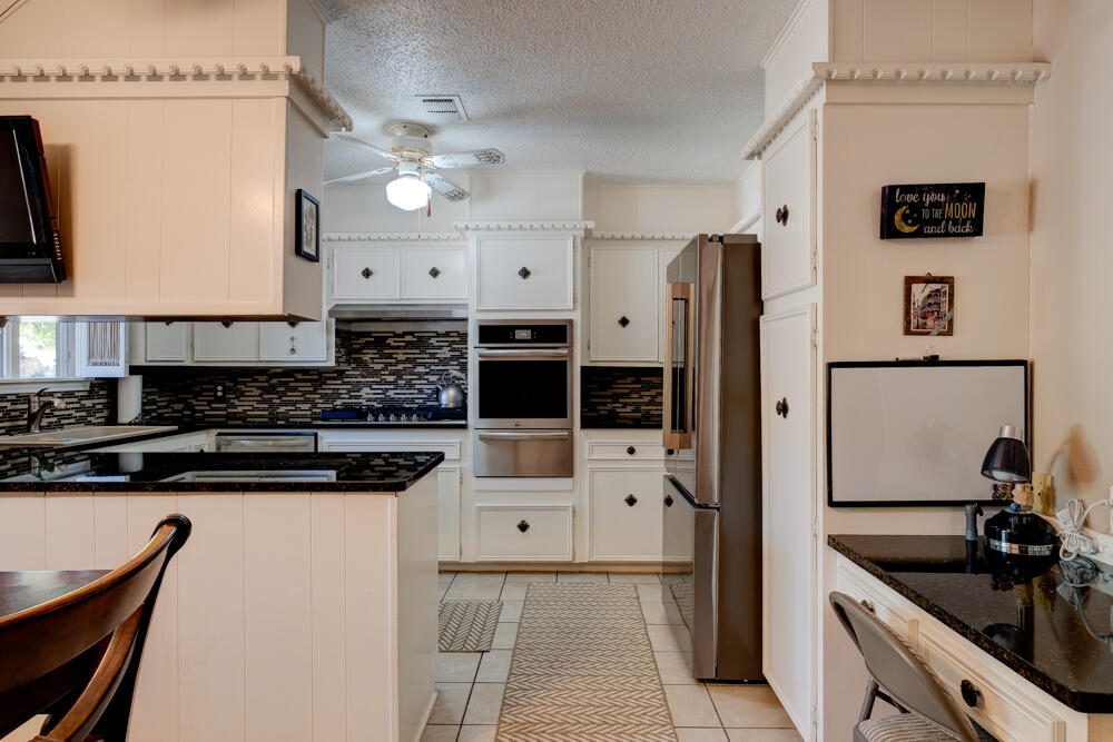 4509 62nd Street Lubbock, TX 79414 - Photo 10 of 20 a kitchen with stainless steel appliances a sink stove and refrigerator