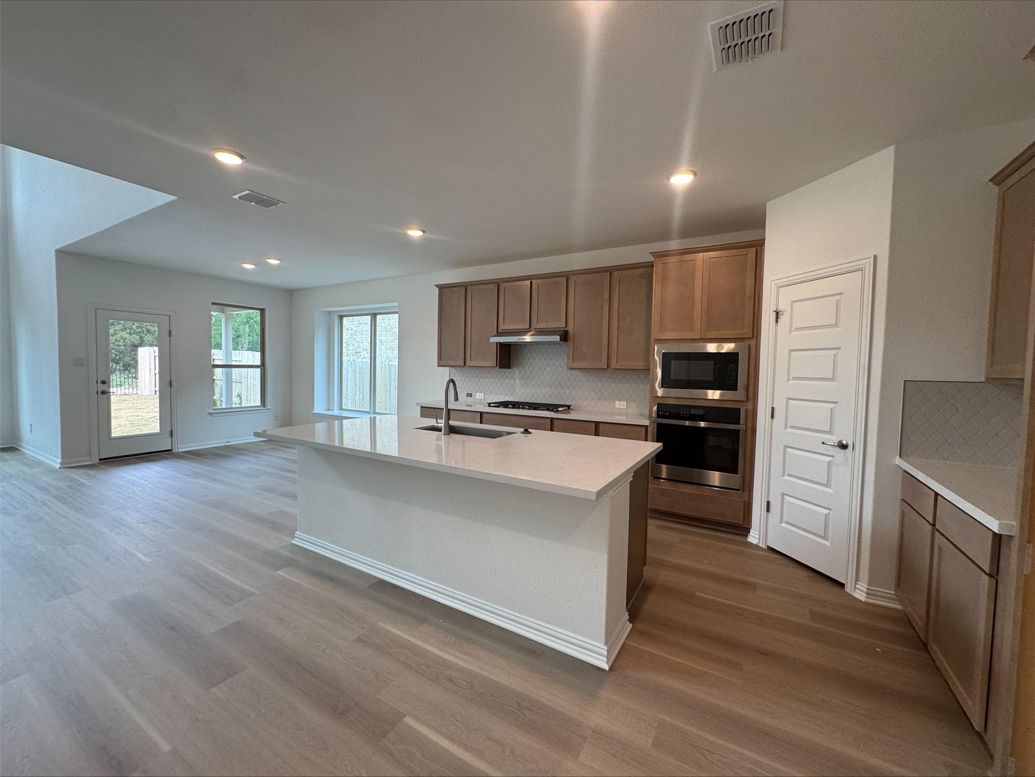 548 Tubman Drive Kyle, TX 78640 - Photo 2 of 13 a kitchen with a refrigerator and a sink