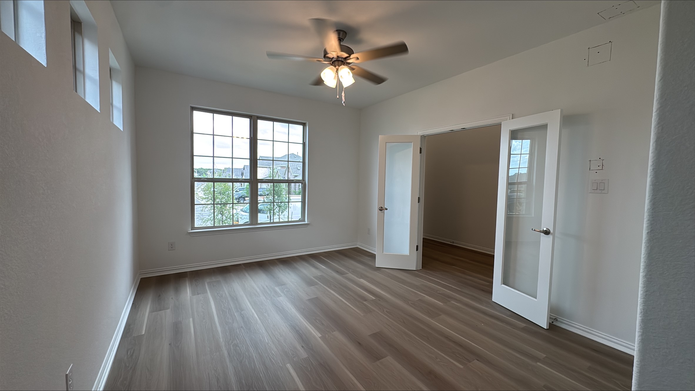 548 Tubman Drive Kyle, TX 78640 - Photo 4 of 13 a view of an empty room with wooden floor and a window