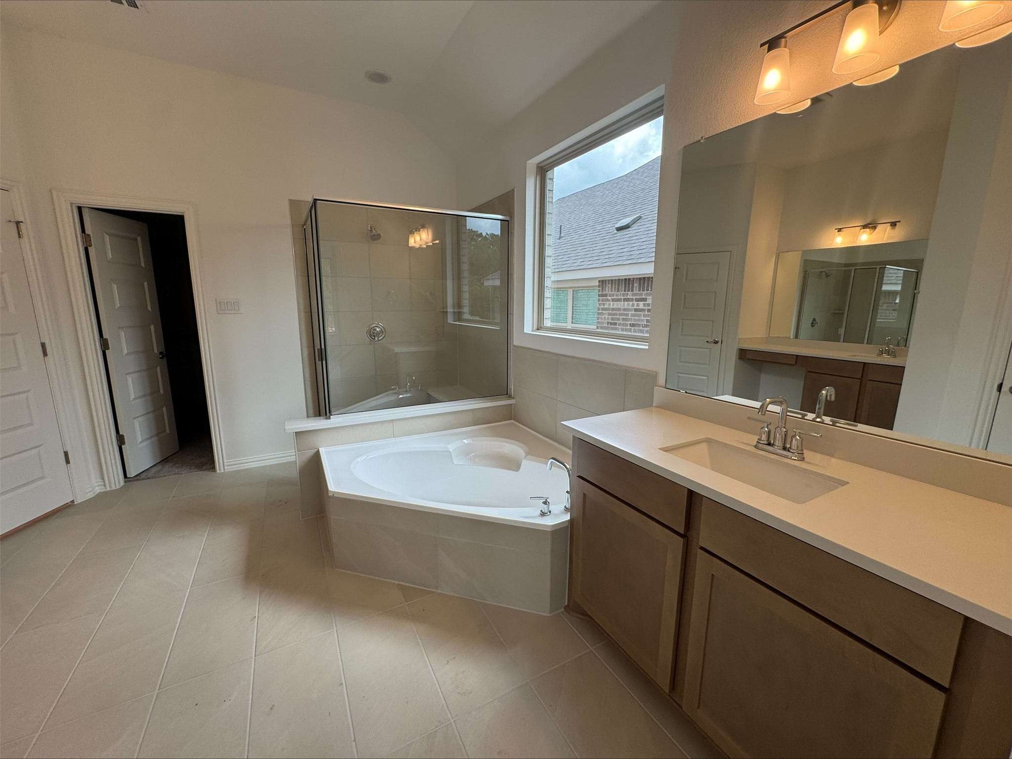548 Tubman Drive Kyle, TX 78640 - Photo 8 of 13 a bathroom with a tub sink and mirror