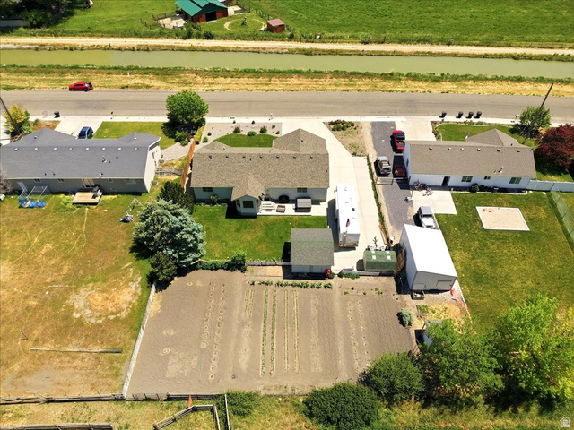 72 Canal Bank Road Garland, UT 84312 - Photo 39 of 40 Aerial perspective showcasing a property with a cultivated garden plot, a separate outbuilding structure, and a secondary shed
