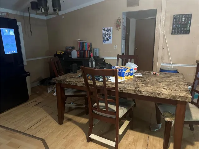 a dining room with furniture and wooden floor