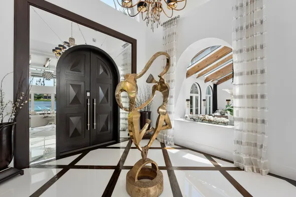 a hallway with a chandelier and living room