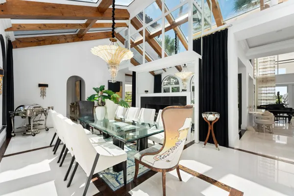 a living room with a large window and chandelier