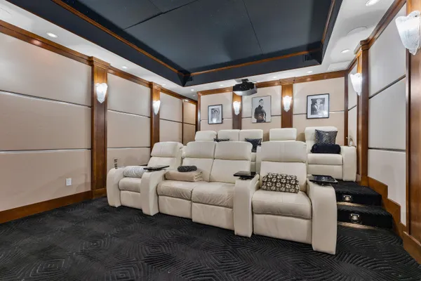 a dining room with furniture a chandelier and wooden floor