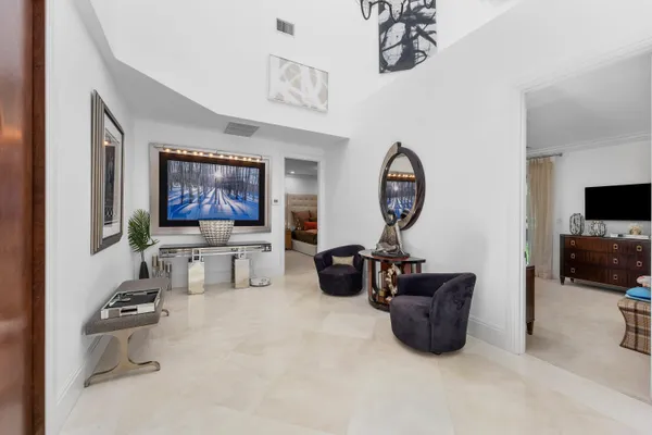 a living room with furniture and a chandelier