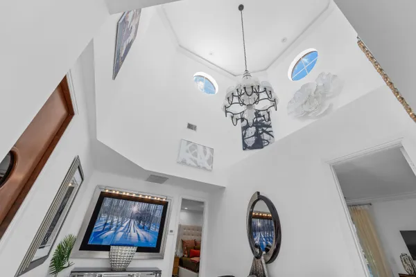 a living room with furniture and a chandelier