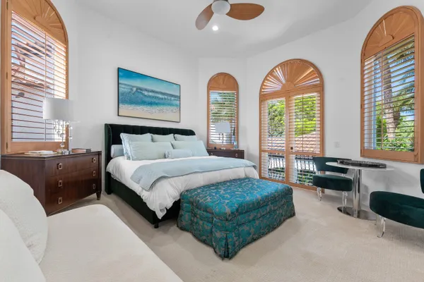 a front view of a house with garden and sitting area